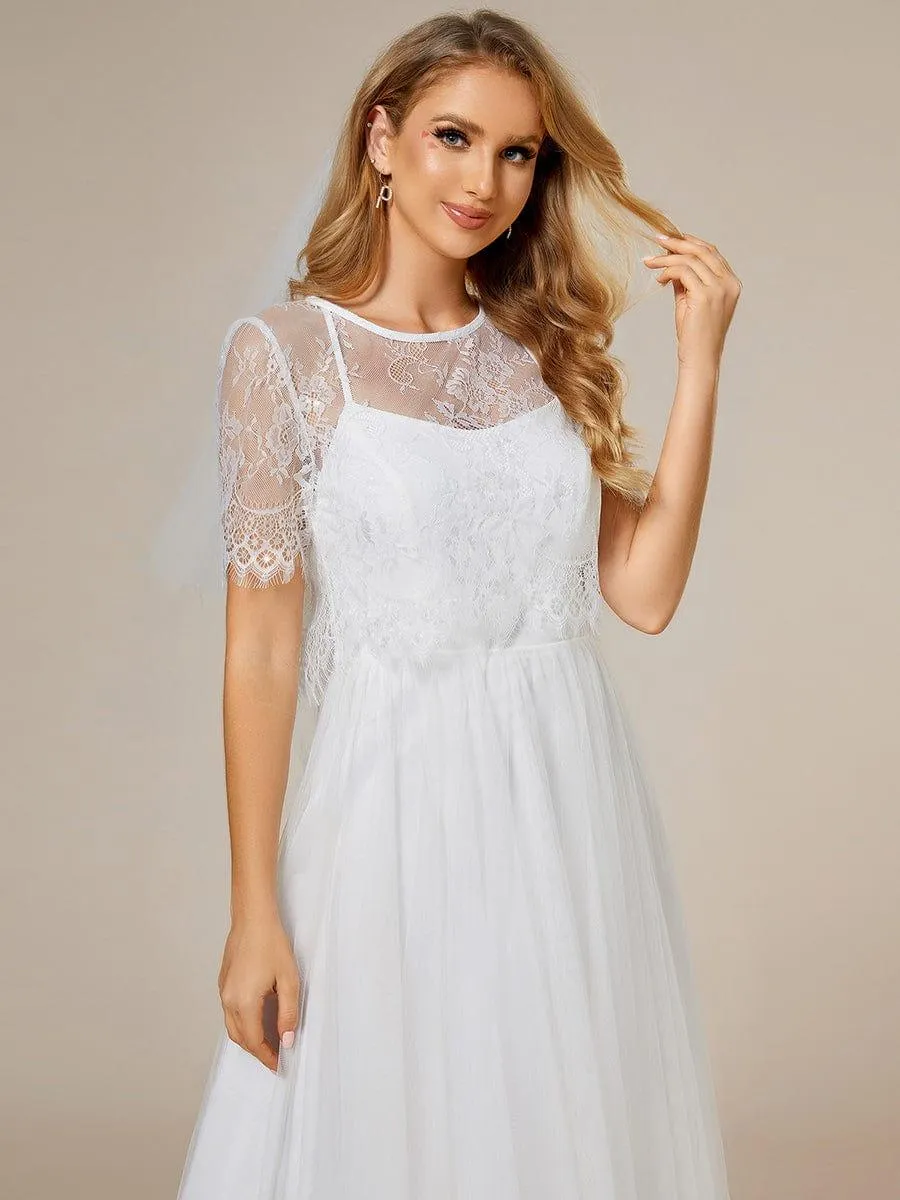 Robe de mariée trapèze avec veste en dentelle et bretelles spaghetti