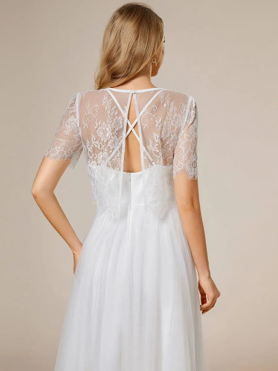 Robe de mariée trapèze avec veste en dentelle et bretelles spaghetti